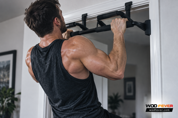 Athlete performing a strict pull-up on a doorway pull-up bar