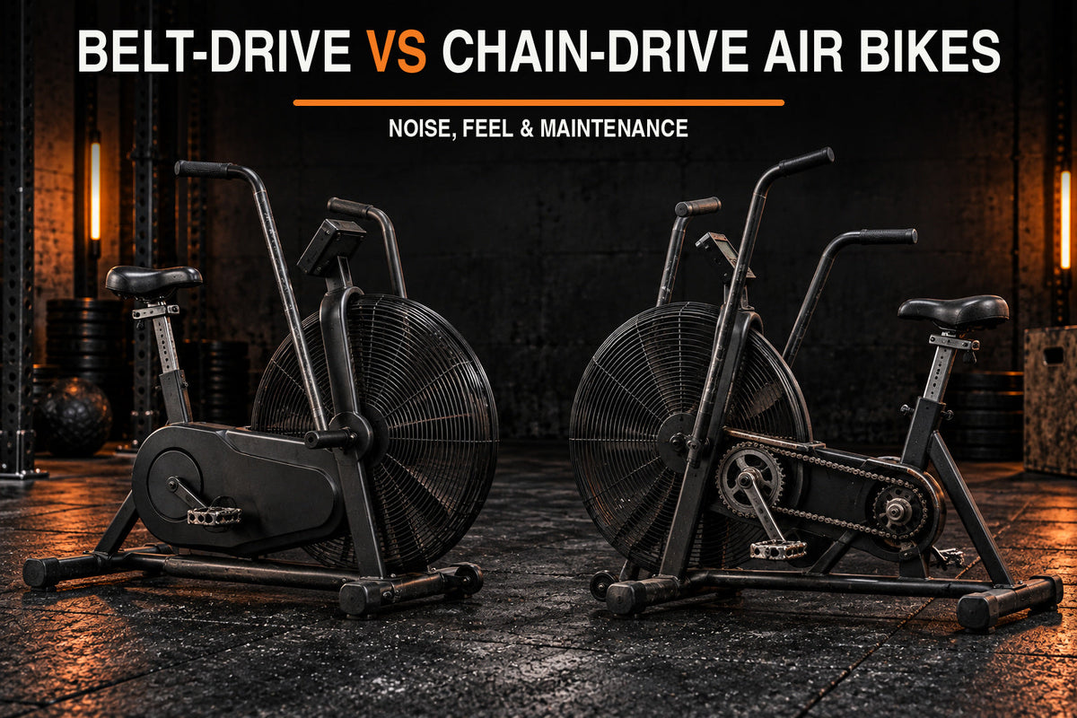 Belt-drive vs chain-drive air bikes comparison in a dark garage gym