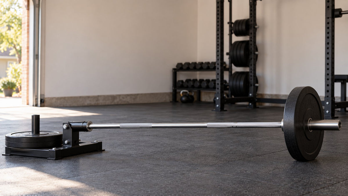 Generic garage-gym landmine setup at rest, with a floor pivot and the working plate resting on the floor
